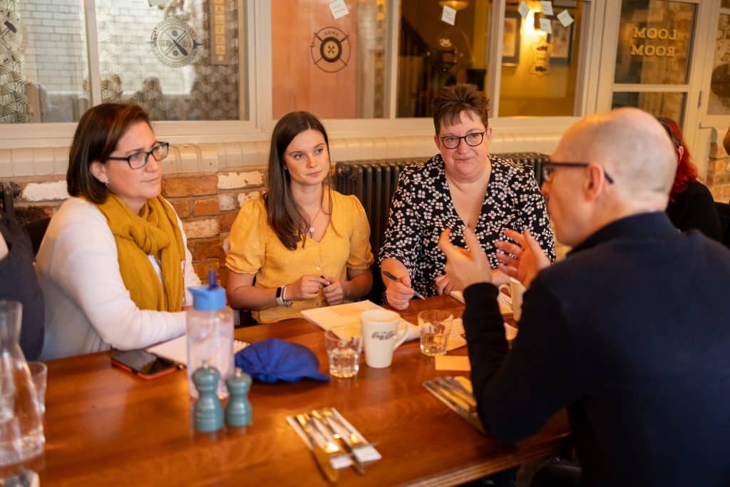 Close up of group discussing at the table 1- colour